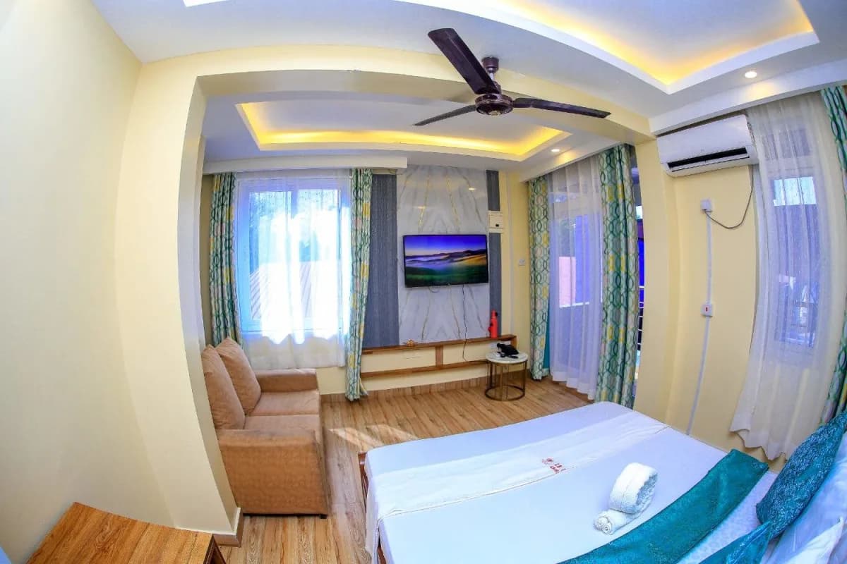 Deluxe room at Lemach Hotel with a king bed and seating area